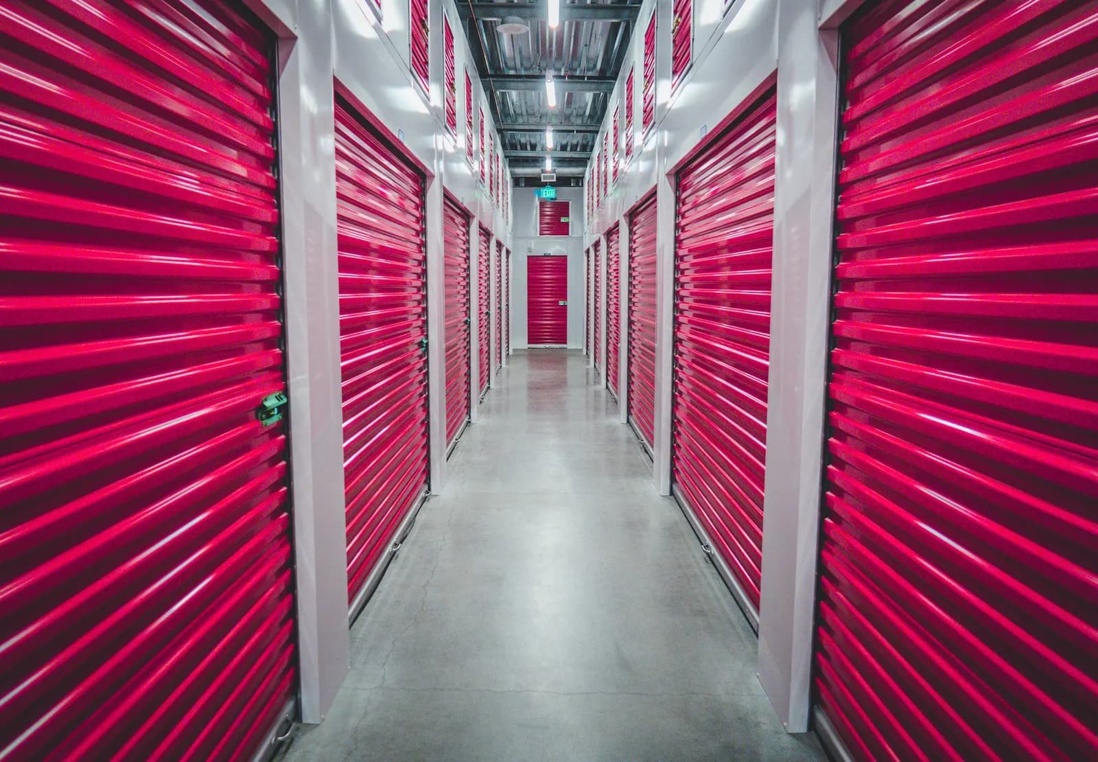 Illustrative photo: corridor of storage units with roller doors